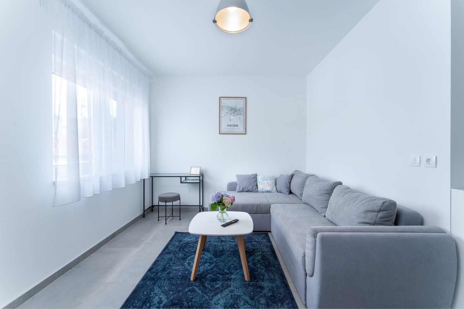 Living room with a corner sofa and television — Sunset